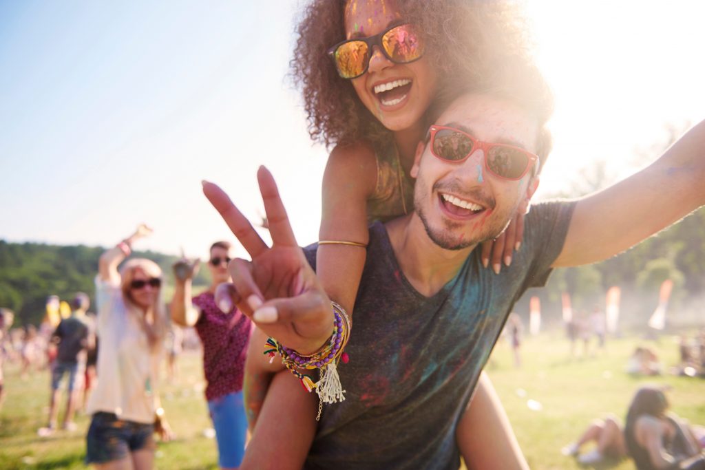 Friends at a festival wearing custom made earplugs from Hearco